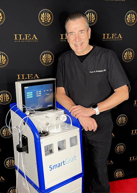Dr. Cesar Aristeinguieta poses with advanced hair restoration technology for the biography section of ILEA Hair Restoration's About Us page.