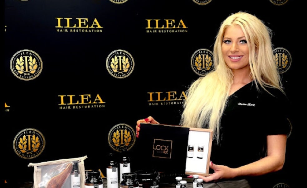 Team member at ILEA Hair Restoration in Houston, Texas, poses with hair restoration treatments for the Biography section of the About Us page.