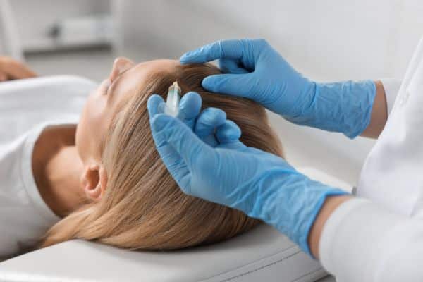 A woman patient undergoing a Female Hair Regrowth Medication.